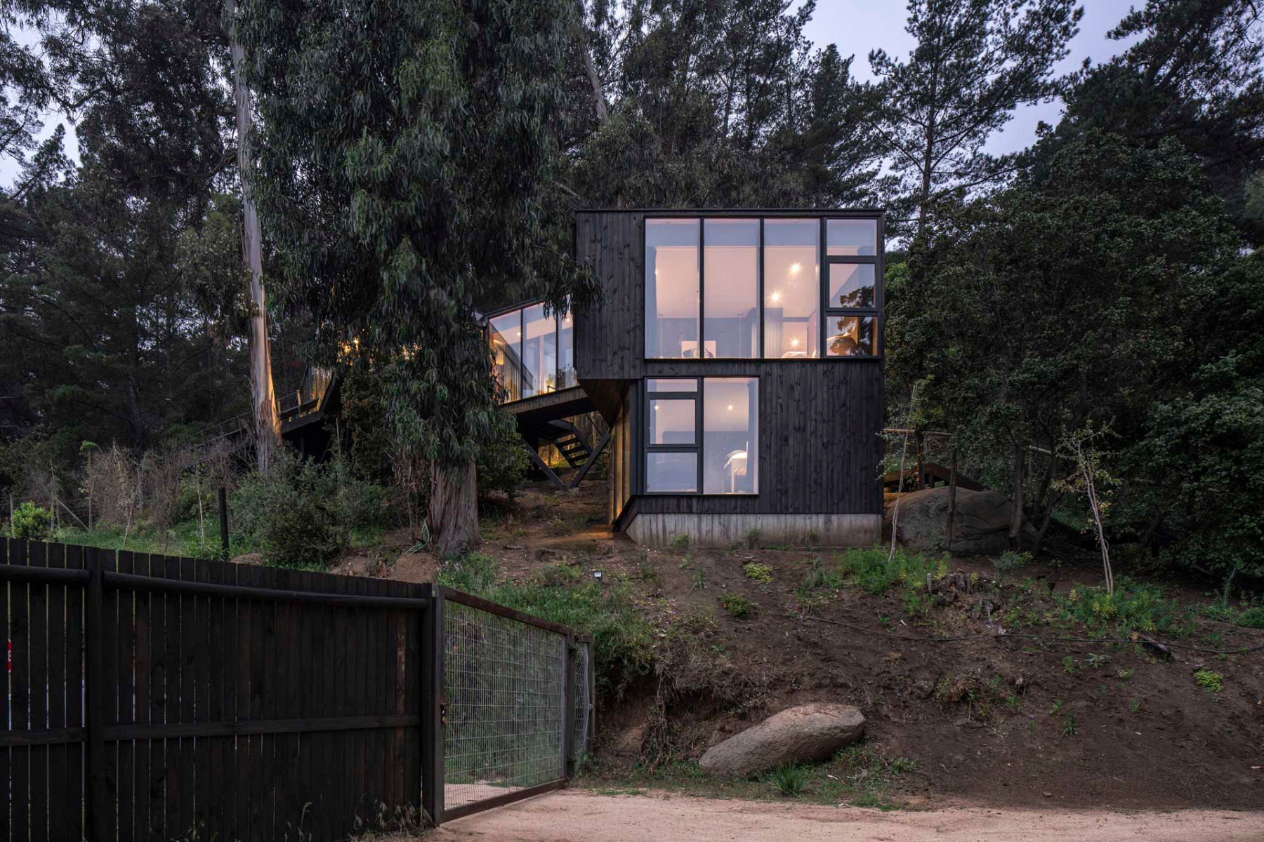 The new building is located further down the slope and is connected to the existing building by a main road. &copy; Nicol&aacute;s Saieh