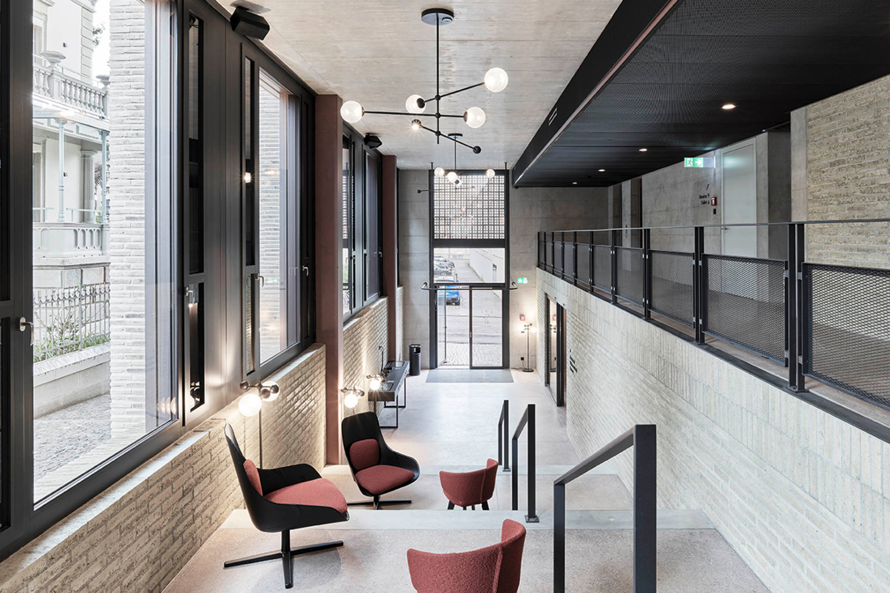 The internal walls are constructed of unfired clay bricks between red-pigmented concrete columns. &copy; Kuster Frey