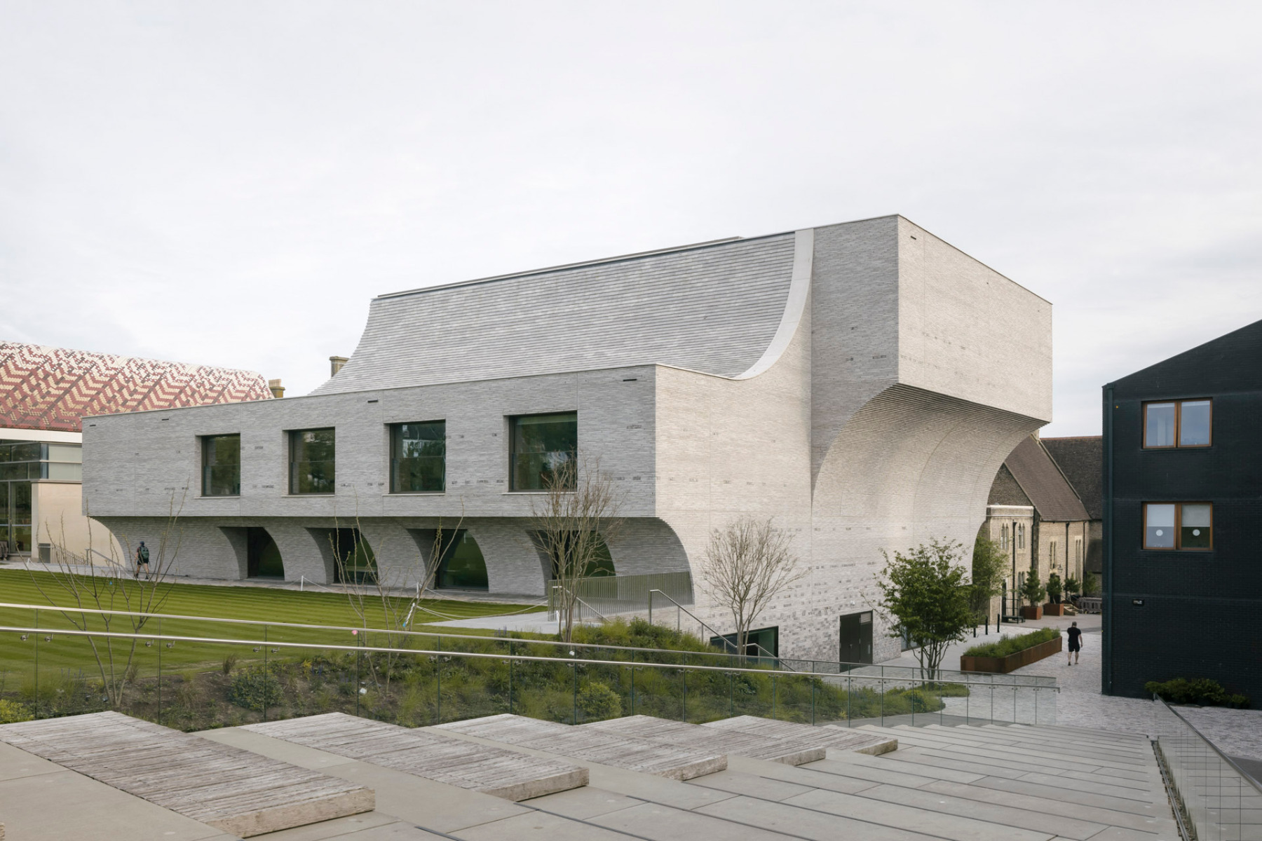 The sculptural structure is clad in a dress of hand-cut grey Seeton bricks. &copy; Stijn Bollaert