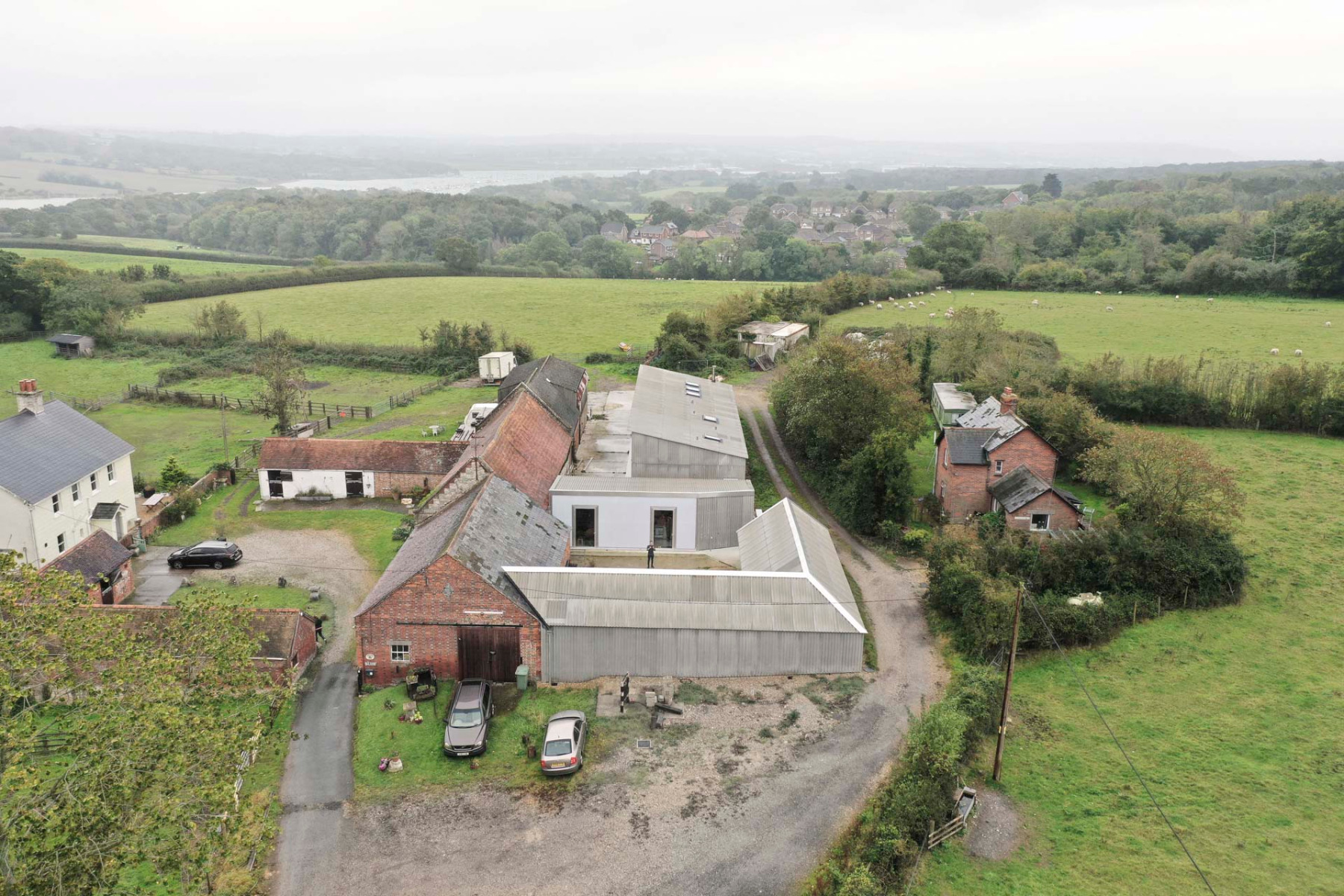 The two refurbished buildings are easily recognised by their corrugated fibre cement cladding. In the background is another owner's building, which was refurbished by a different architect using the same range of materials. &copy; James Eagle
